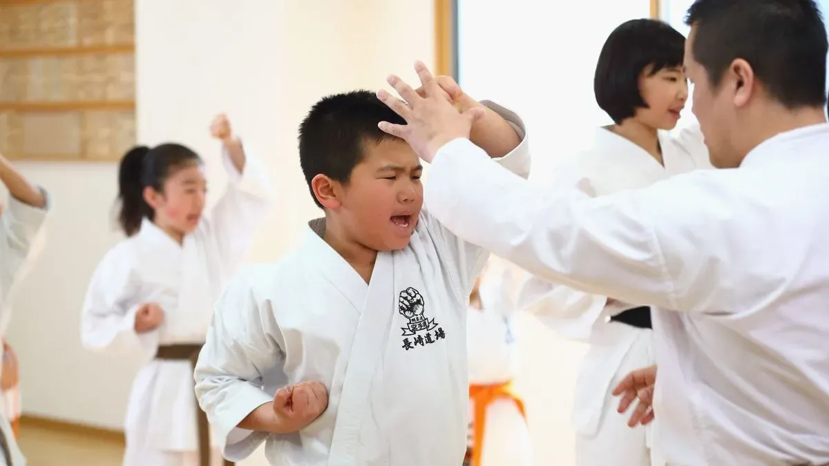 Young karate students learning techniques in Stanwell