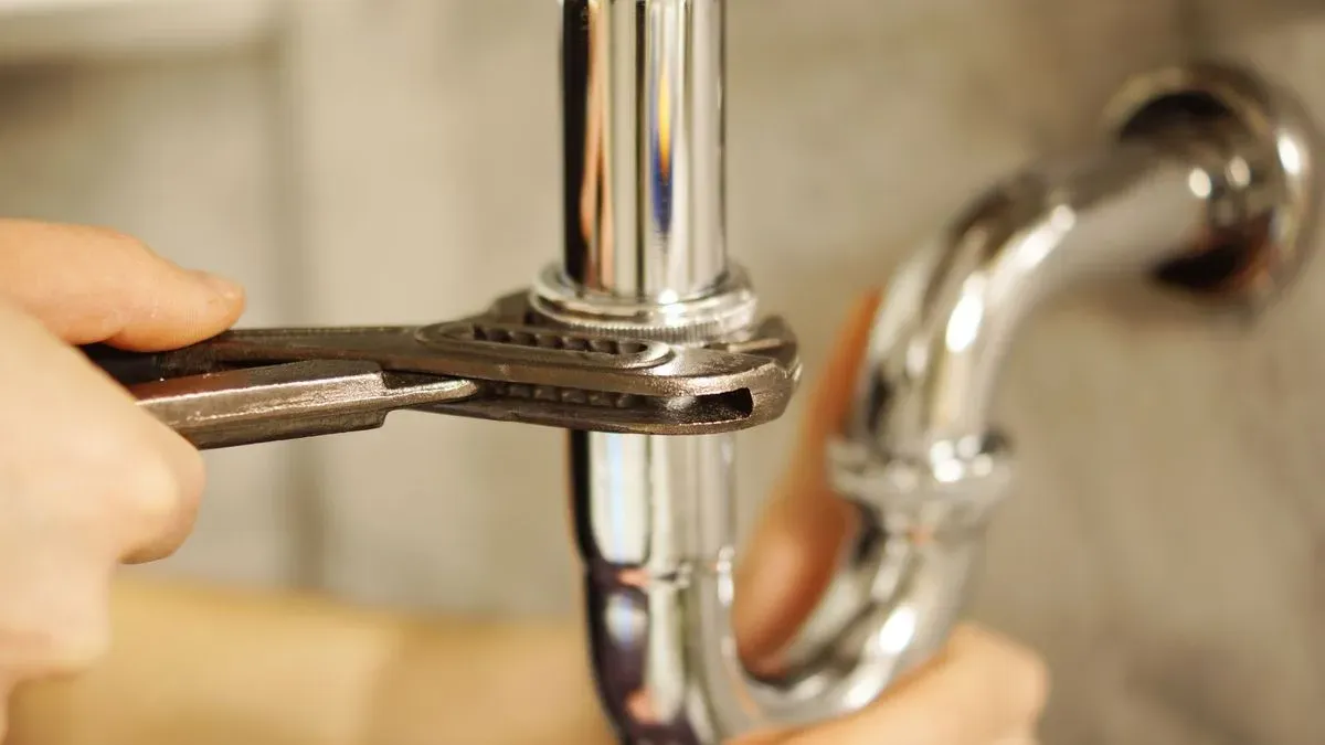 Plumber fixing a pipe in Guildford household