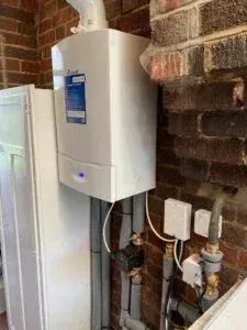 Technician checking a boiler's components in Guildford