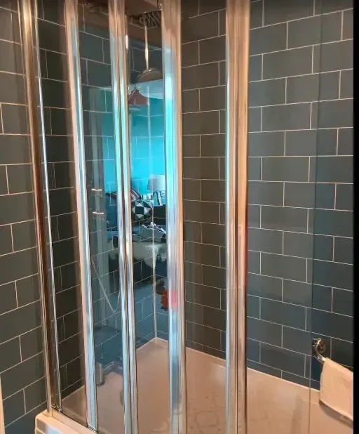 Professional tiler working on bathroom tiles in St Leonards-on-Sea
