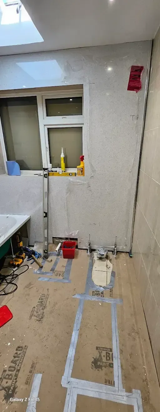Local technician assessing a bathroom repair in area