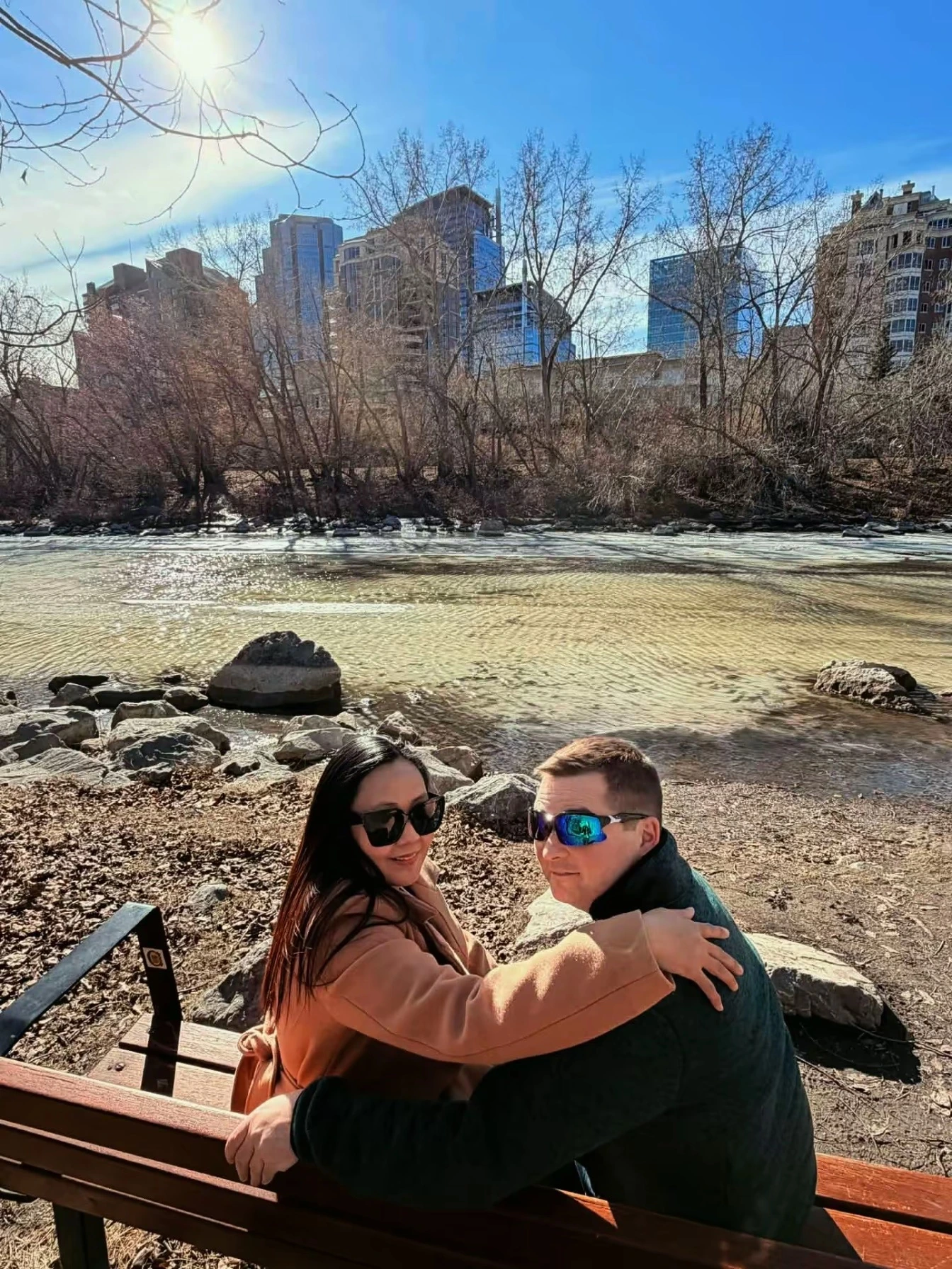 Couple sitting on bench looking back