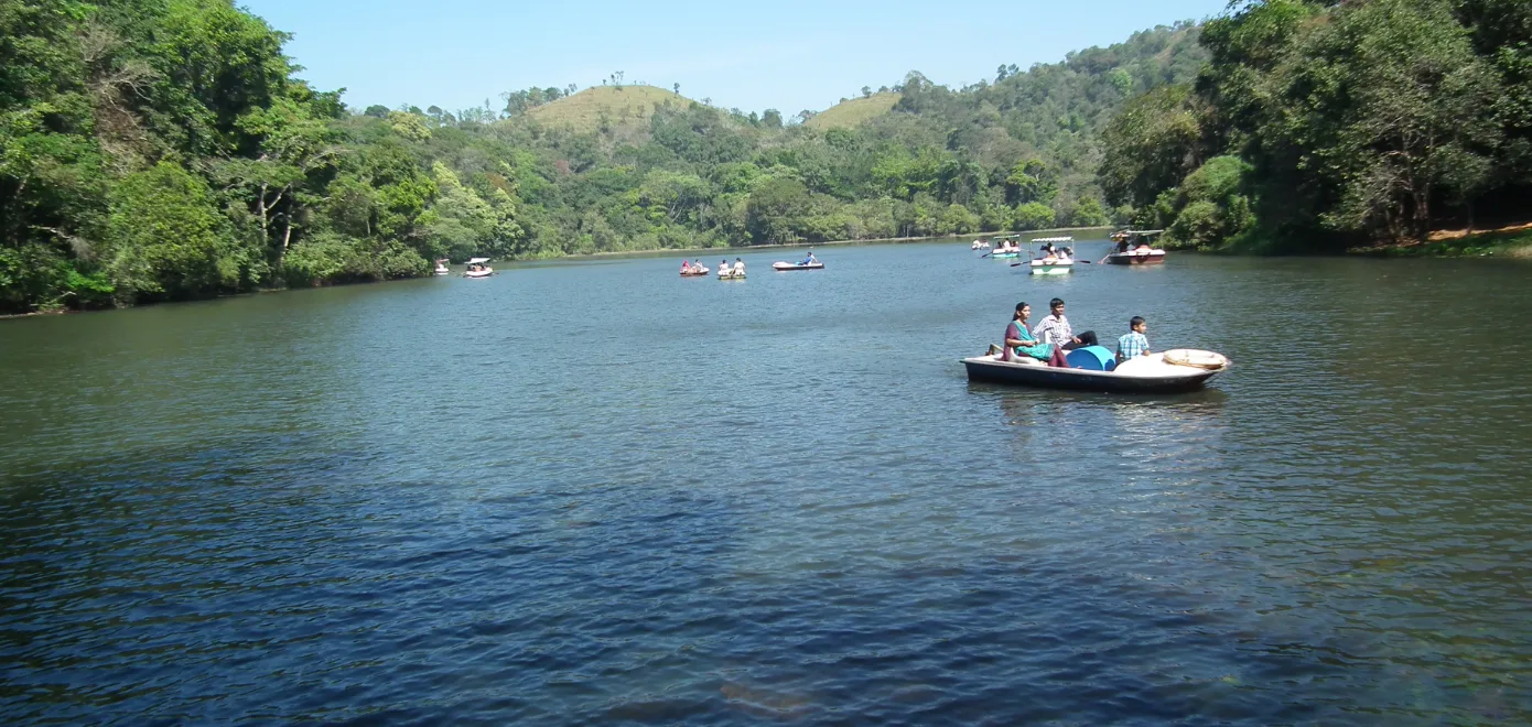 Pookode Lake in Wayanad surrounded by evergreen forest hills
