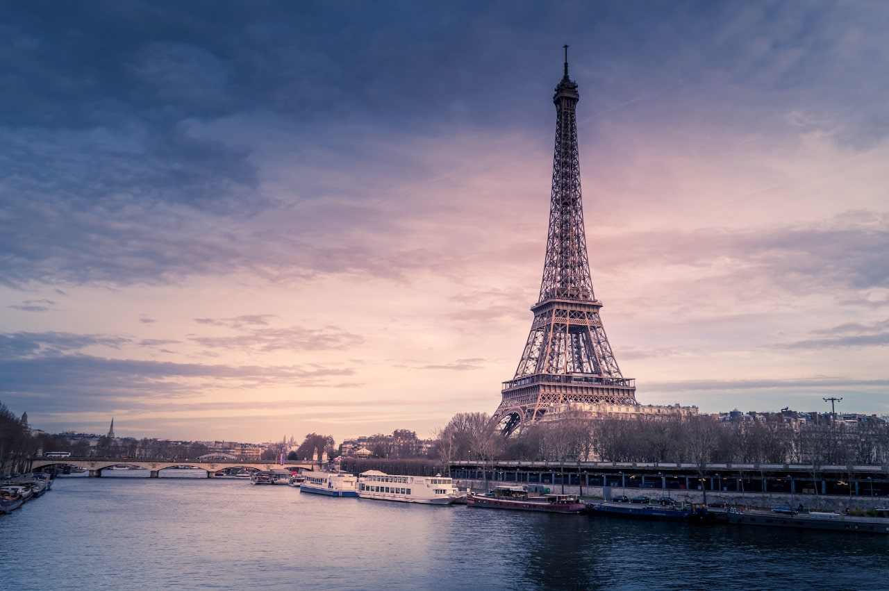 The Eiffel Tower towers over the Seine River in Paris, France.
