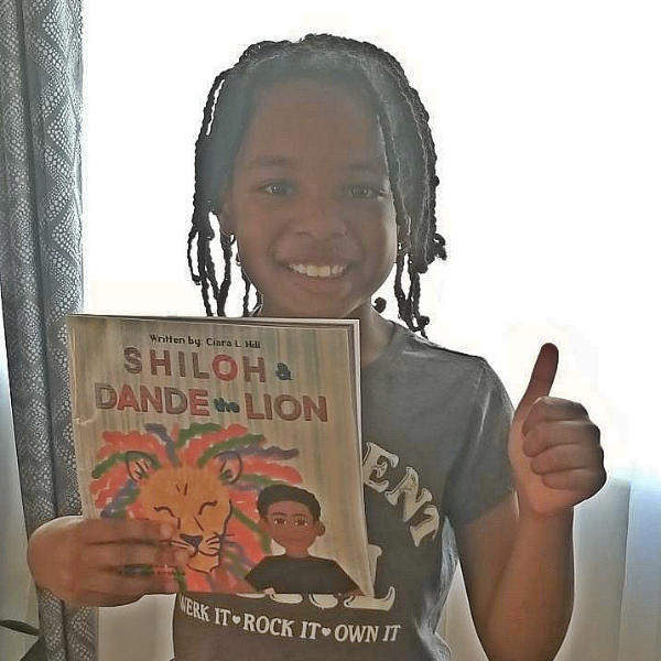 Girl in gray shirt holding book