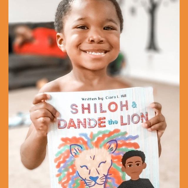 Boy holding book orange stripes