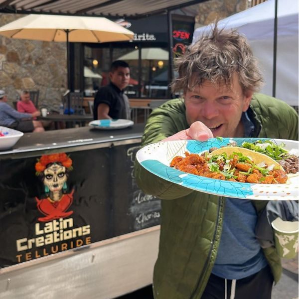 man in green showing plate