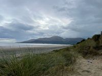 View of beach from dunes, Mourne mountains in the distance 