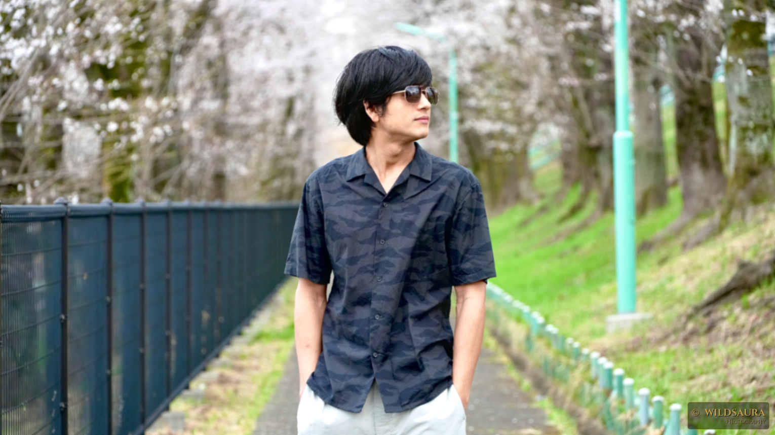 Man in Sunglasses on a Cherry Blossom Lined Path