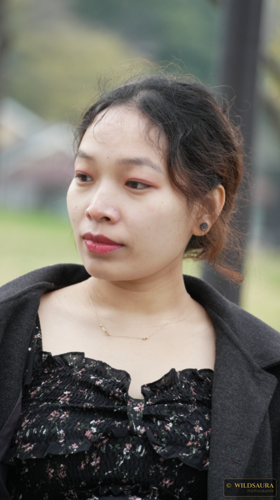 Outdoor Portrait of a Young Woman with Thoughtful Gaze