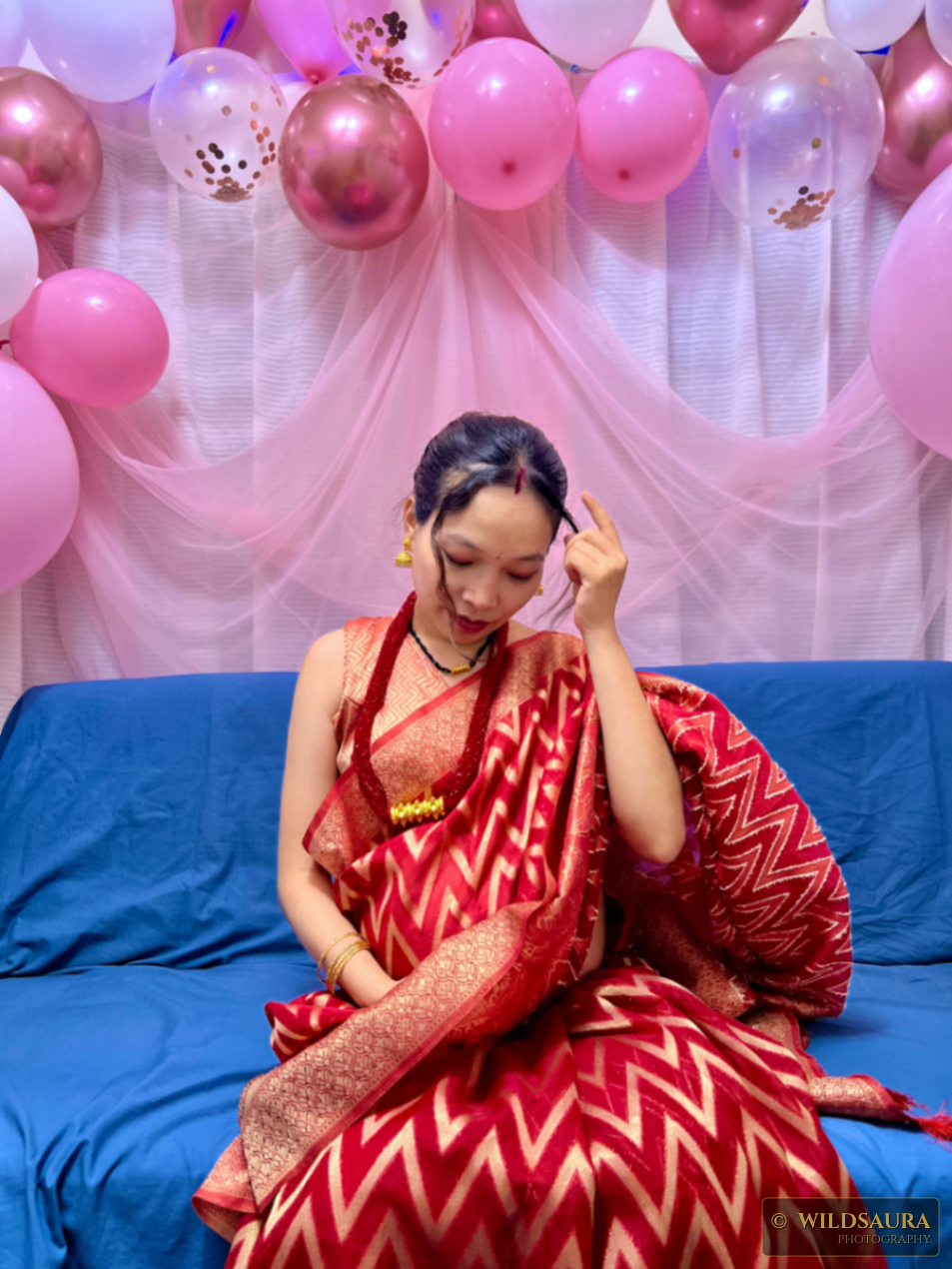 Woman in Red Saree at a Festive Celebration