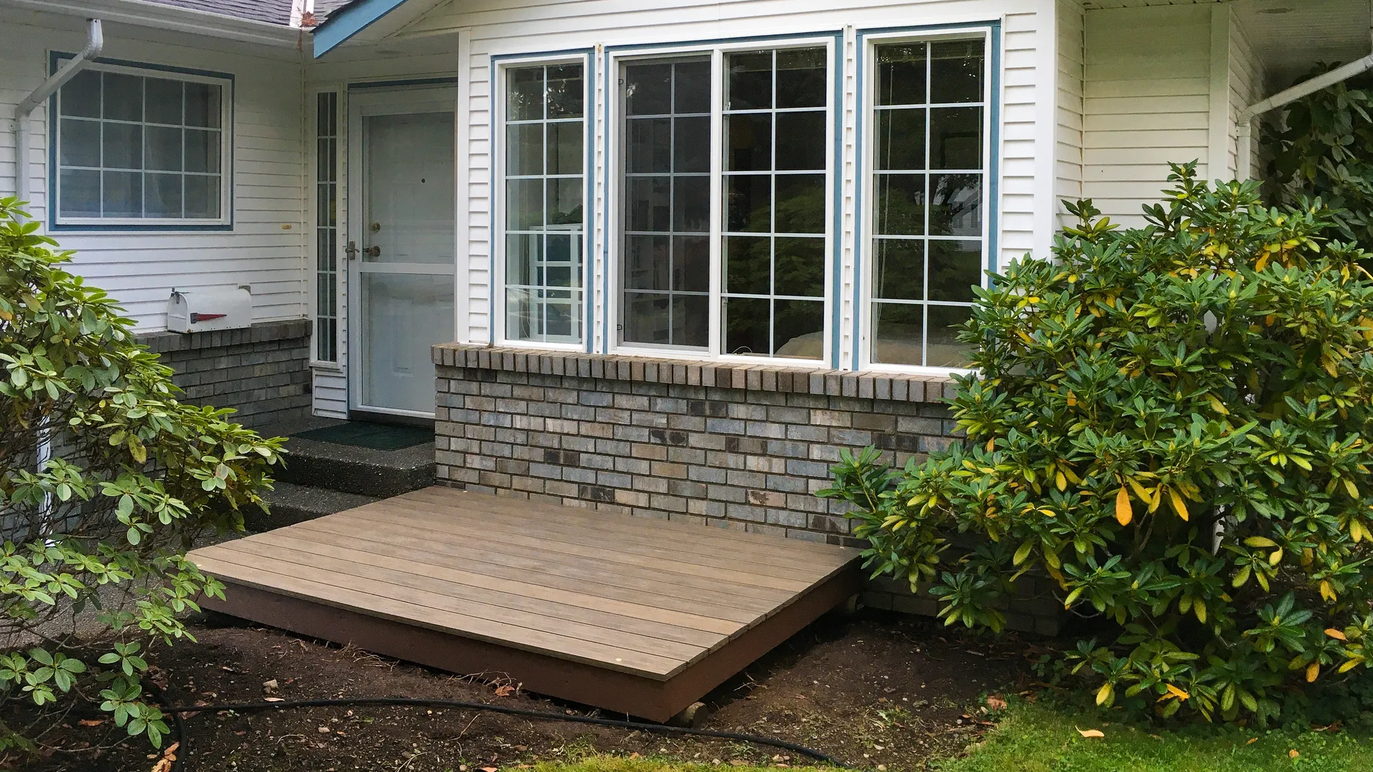 A Perma-Deck creates an accessible outdoor space in a residential setting. The deck features Havana Brown recycled plastic lumber.