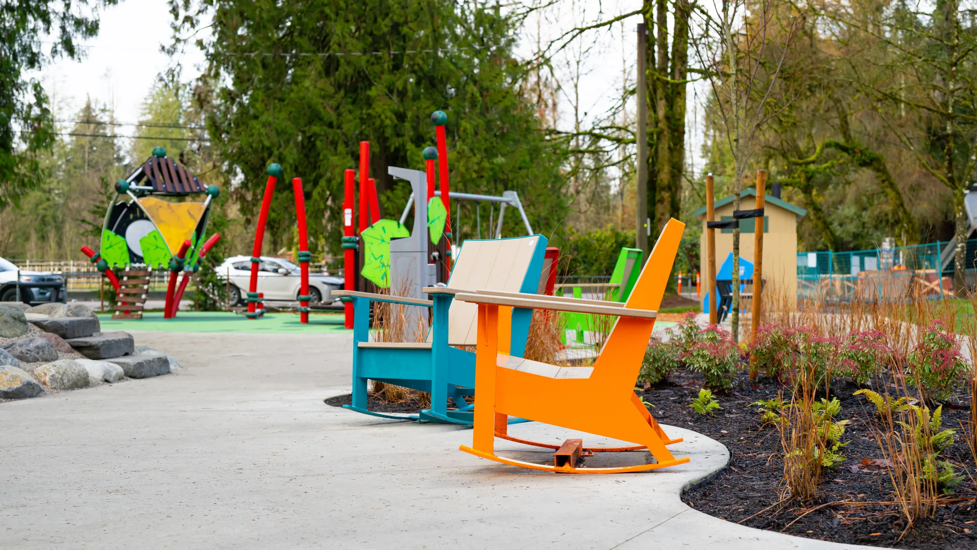 These colorful rocking chairs add a playful touch to Maple Ridge Park. The chairs feature recycled plastic lumber and powder-coated metal frames.