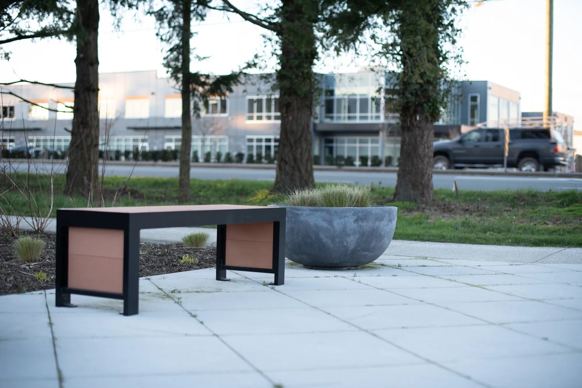 This backless bench features recycled plastic lumber and a powder-coated metal frame. It provides simple, durable seating for public spaces.