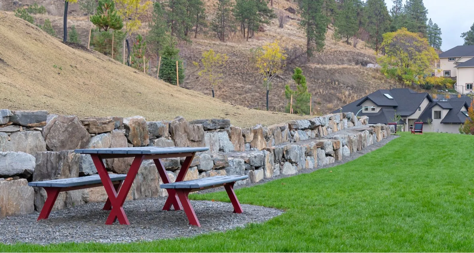 Bayview picnic table with recycled plastic lumber and powder-coated metal frame. This accessible picnic setting is located in a landscaped park.