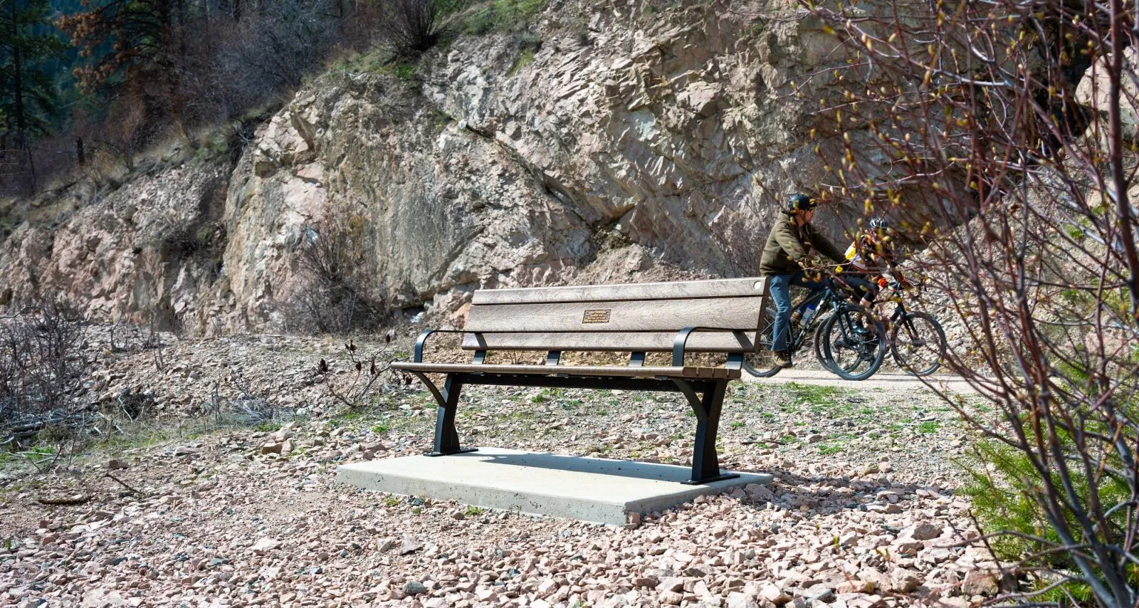 A Parker bench provides a resting spot along the Okanagan Rail Trail in Lake Country, British Columbia. The bench features recycled plastic lumber and a durable metal frame.