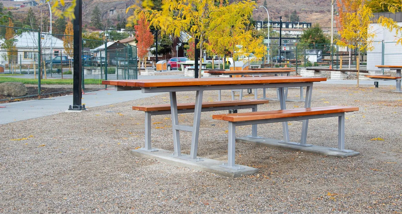 Wheelchair accessible picnic tables provide an inclusive outdoor dining space. The tables feature durable frames and modified pine tops and seats.
