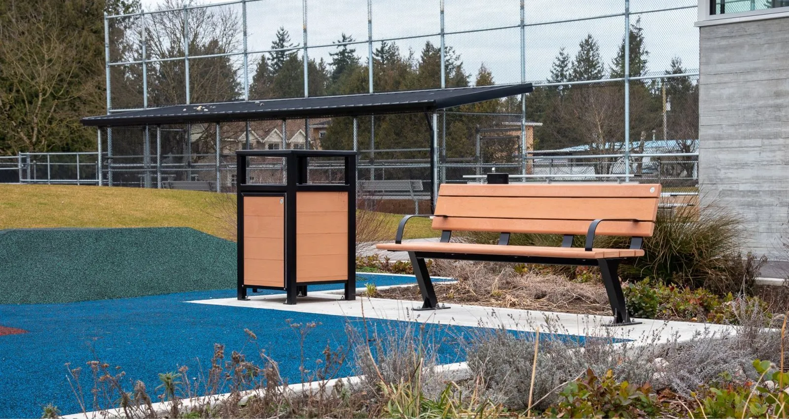 Bayview bench and Urban Form waste receptacle create a coordinated site furnishing solution. The bench offers comfortable seating, while the waste receptacle provides convenient disposal in an outdoor setting.