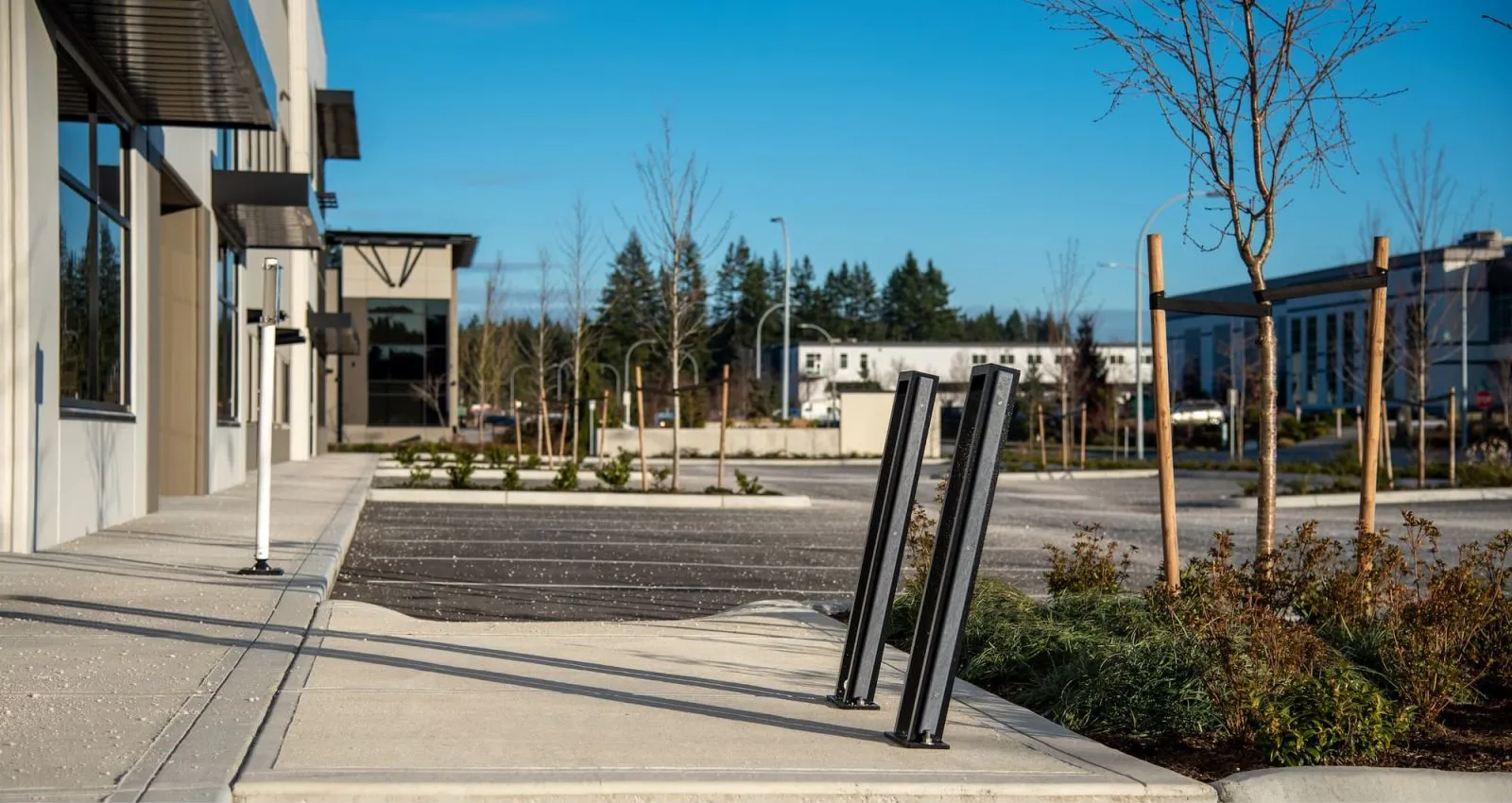 These Urban Form bike racks provide secure parking for cyclists outside a modern building. The sleek design complements the surrounding architecture and landscaping.