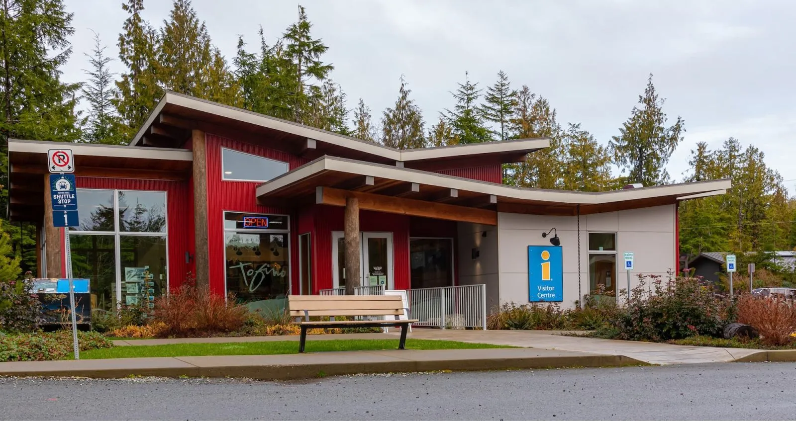 A Bayview bench sits outside the Visitor Information Center in Tofino, British Columbia. The bench provides a comfortable resting spot for visitors.