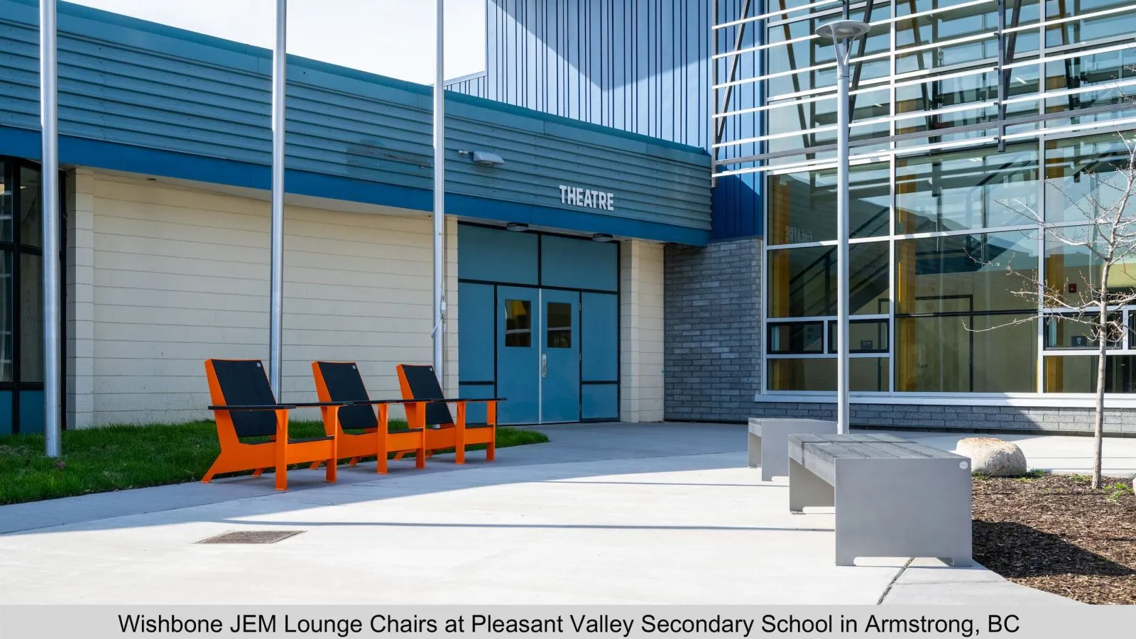 JEM Lounge Chairs provide comfortable outdoor seating at Pleasant Valley Secondary School in Armstrong, British Columbia. The chairs feature black recycled plastic lumber seats and vibrant orange frames.