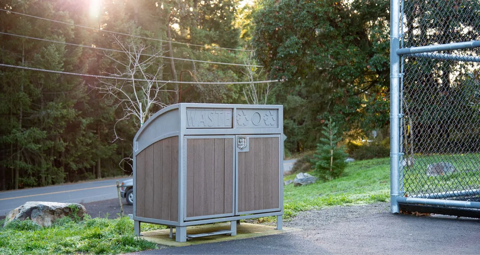 This large capacity waste and recycling station features a curved top and durable recycled plastic lumber. Ideal for parks and public spaces, it helps keep environments clean and organized.