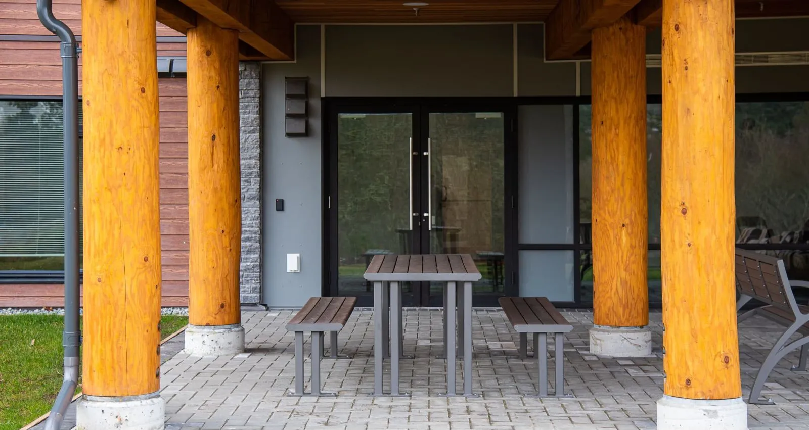 Larson picnic table with benches provides a comfortable outdoor seating area. The table features a durable frame and recycled plastic lumber.