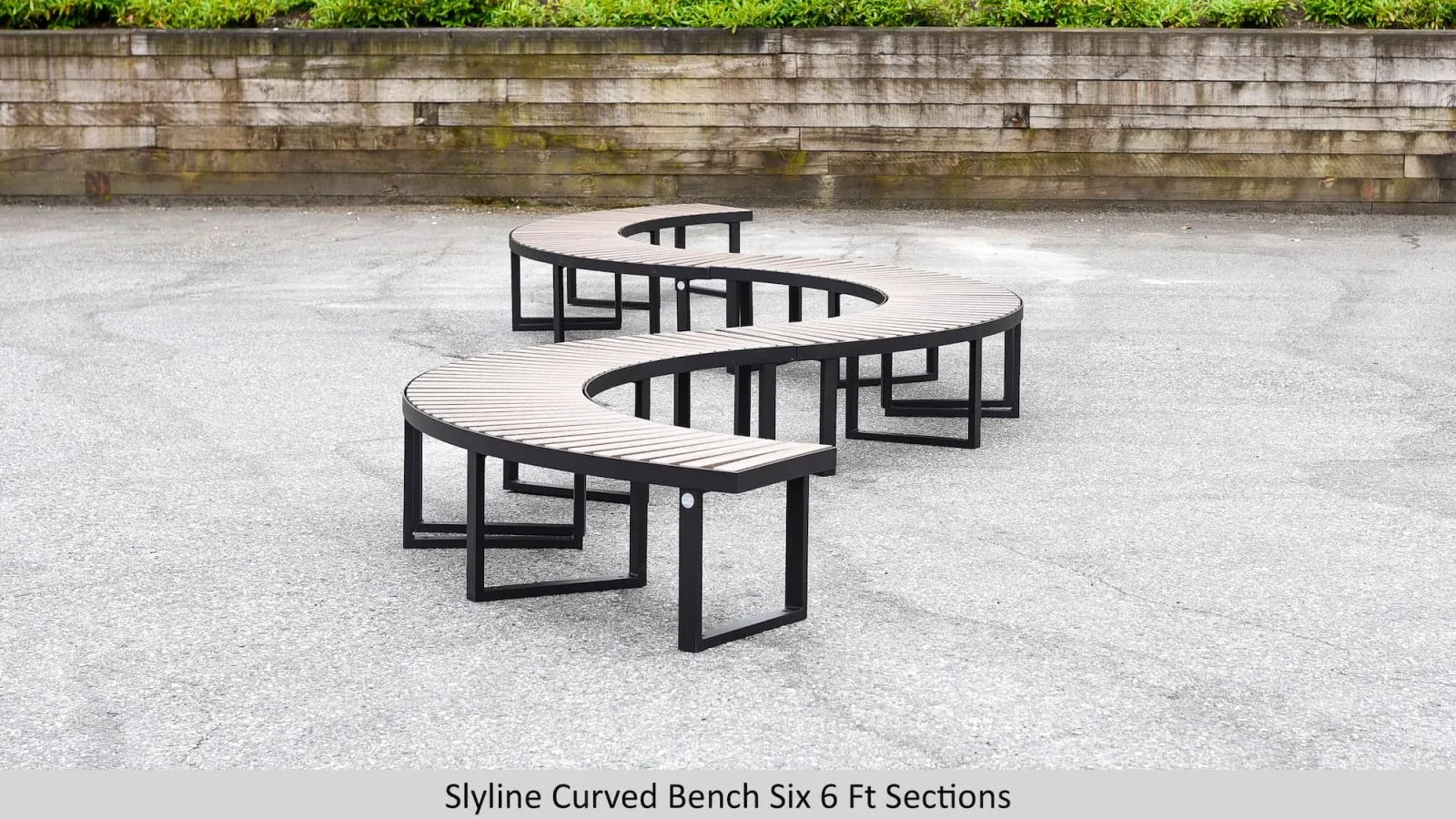 Six Skyline curved benches create a unique serpentine seating arrangement. The benches feature recycled plastic lumber slats and a durable powder-coated metal frame.