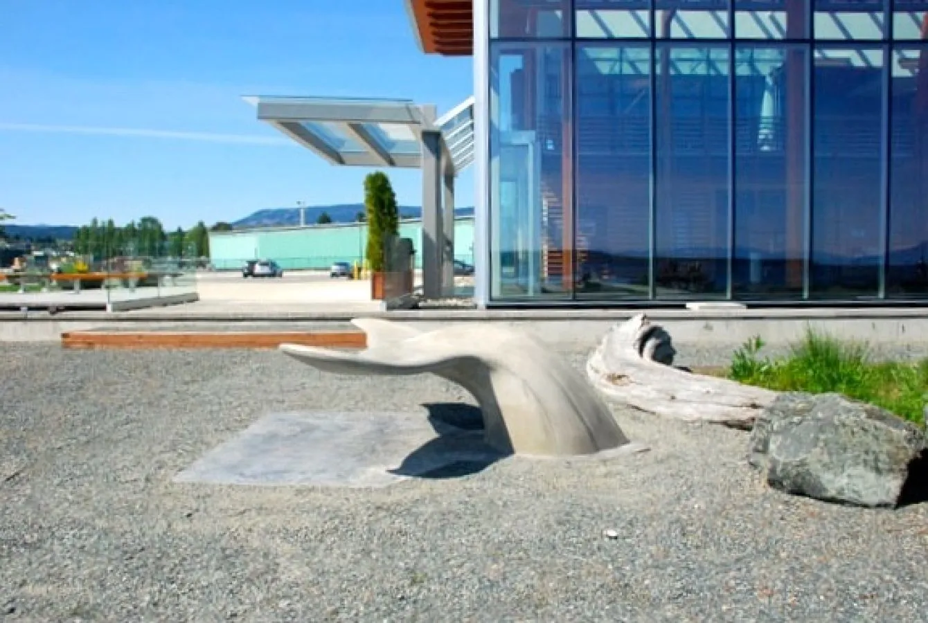 Concrete whale tail bench installed at the Cruise Ship Terminal in Nanaimo, British Columbia. This unique bench provides seating and adds an artistic element to the waterfront area.
