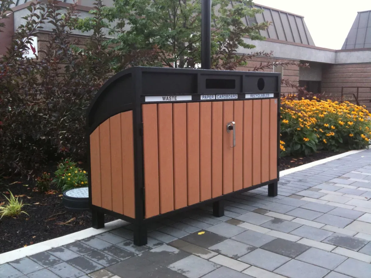 Triple recycling station with separate compartments for waste, paper/cardboard, and recyclables. The unit features recycled plastic lumber and a black powder-coated frame, suitable for outdoor use.