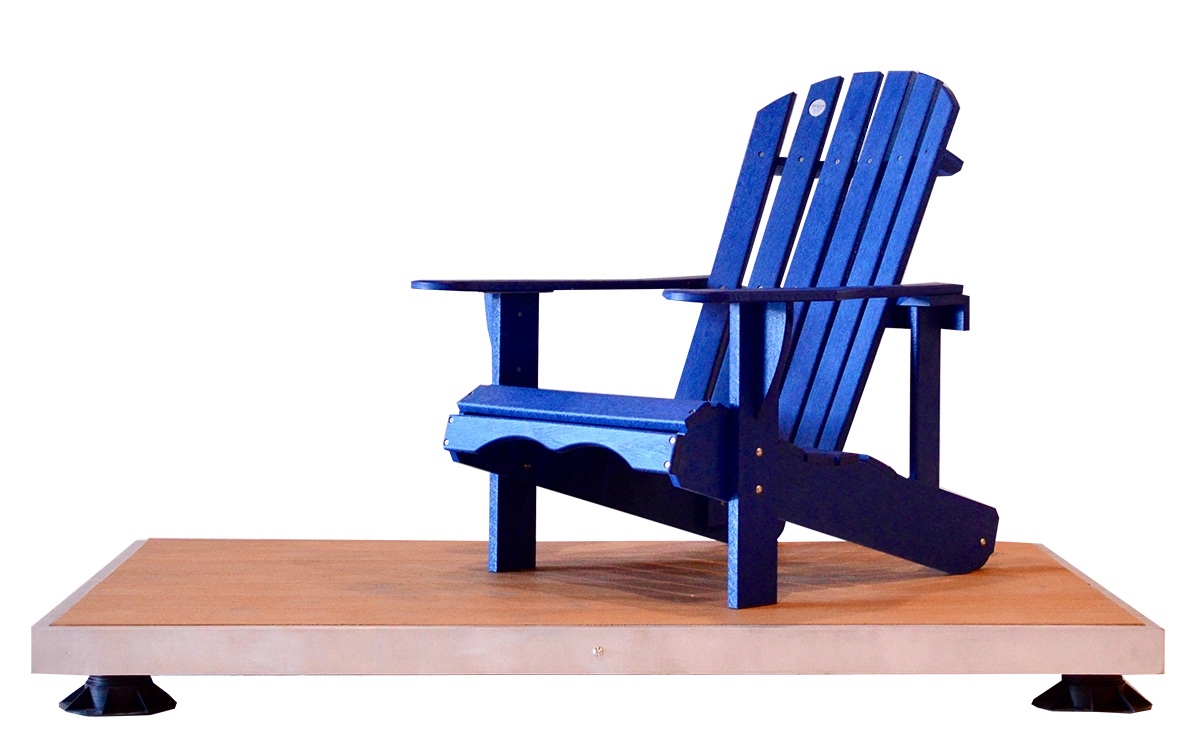 Adirondack chair made from recycled plastic lumber in a studio setting. The chair is a deep blue color and sits on a wooden platform.