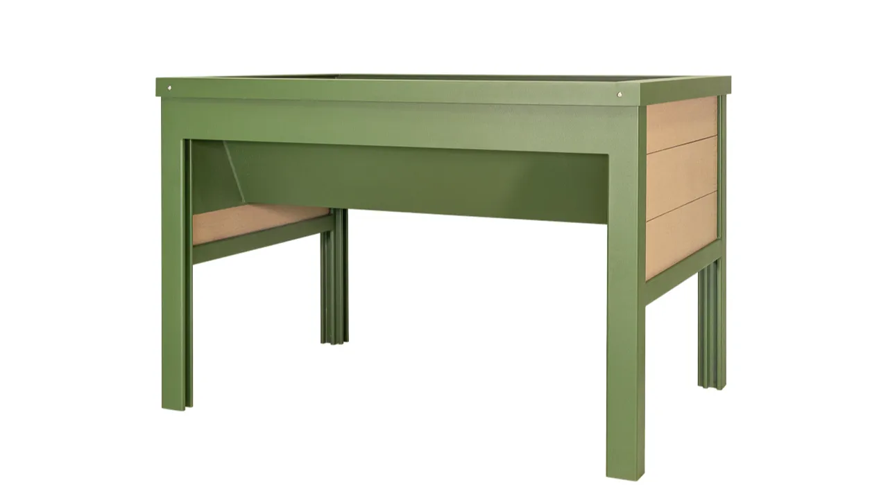 A raised planter box with a green frame and tan recycled plastic lumber panels. This wheelchair-accessible planter is ideal for gardens and public spaces.
