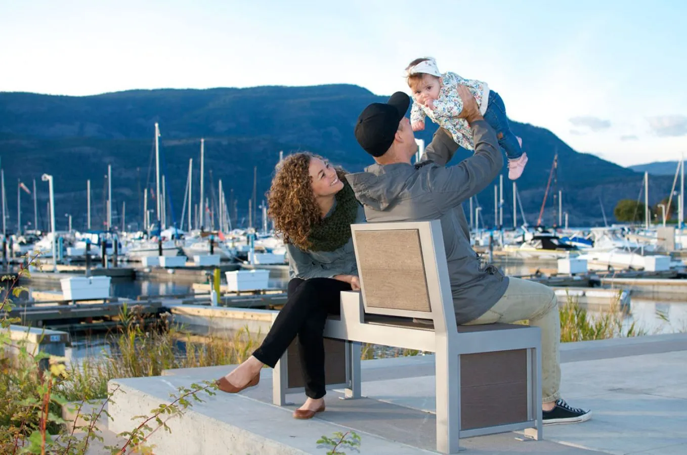 Urban Form Split Back Bench provides comfortable seating at a marina. The bench features a modern design with a split back and durable recycled plastic lumber.