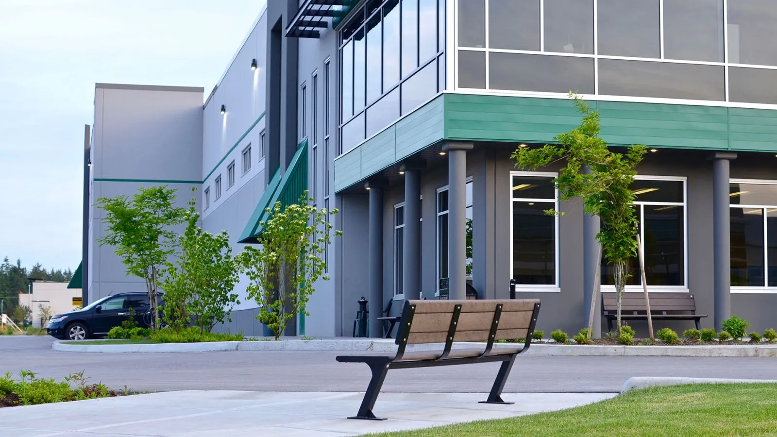 Bayside benches provide comfortable seating in a commercial setting. The benches feature recycled plastic lumber and a durable metal frame.
