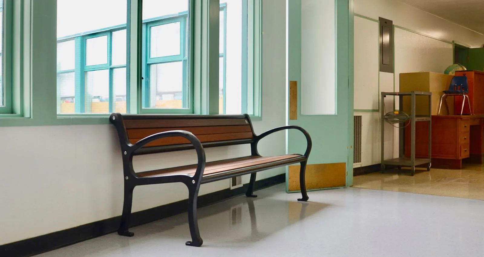 A Mountain Classic bench provides seating inside Rosemont Elementary School. The bench features recycled plastic lumber and a powder-coated metal frame.