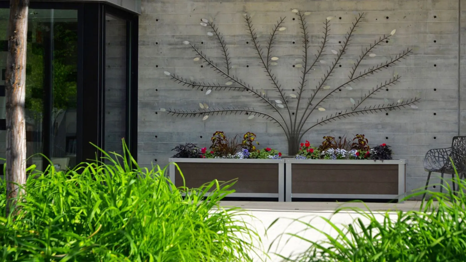 Rectangular self-watering planters enhance the entrance to the Edmonton Valley Zoo. These durable planters add greenery and visual interest to the outdoor space.