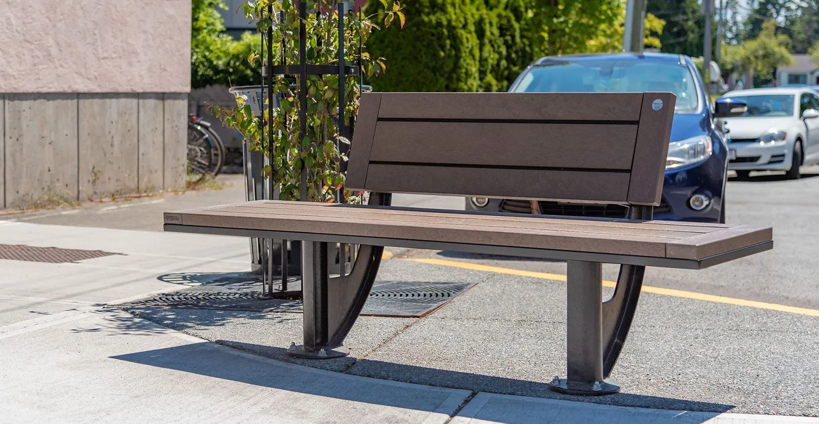 The SurRe bench provides comfortable seating in an outdoor setting. This bench features recycled plastic lumber and a powder-coated metal frame.
