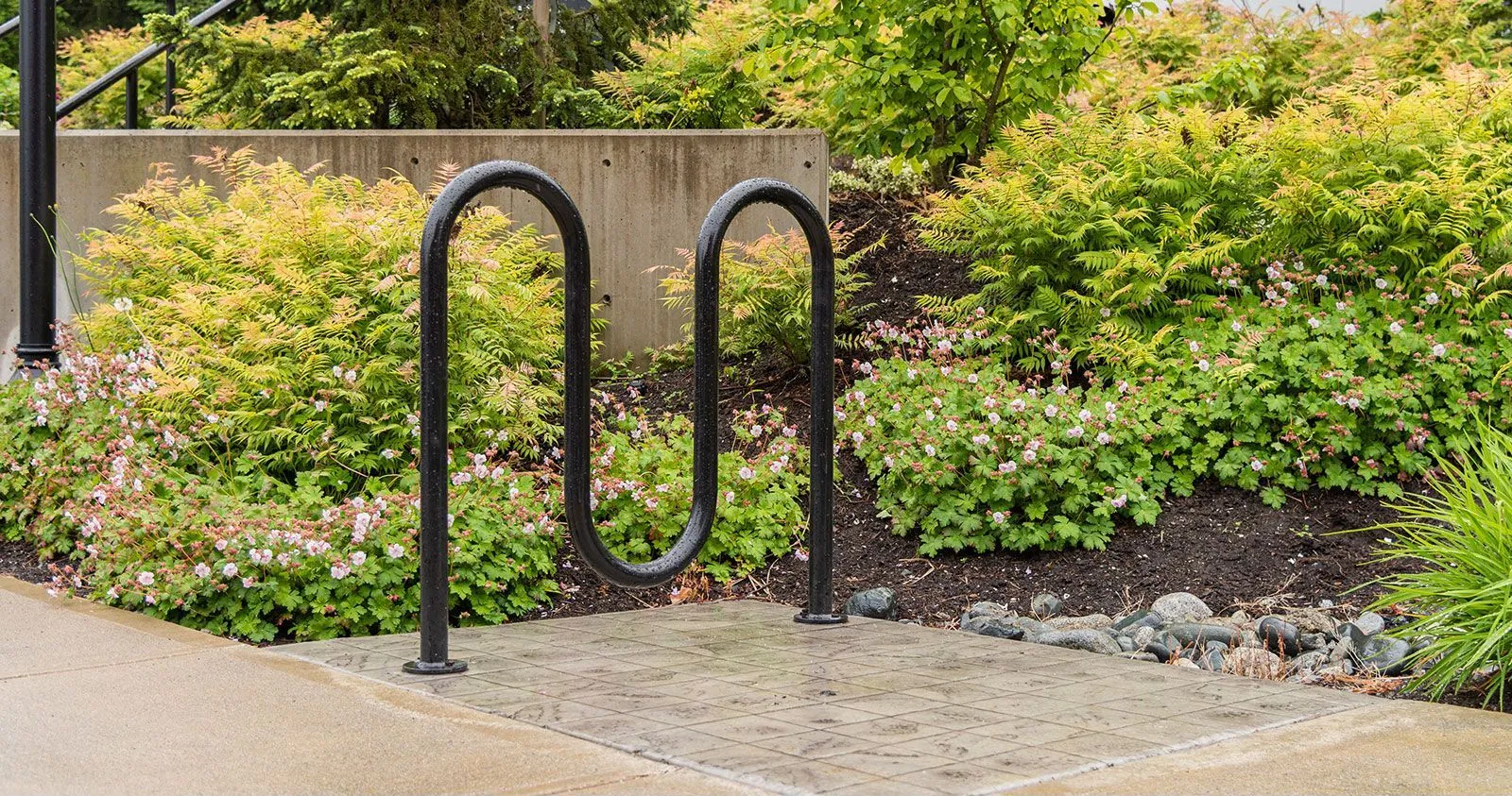 The Surf bike rack provides secure parking for up to 5 bikes. Its curved design complements any landscape.
