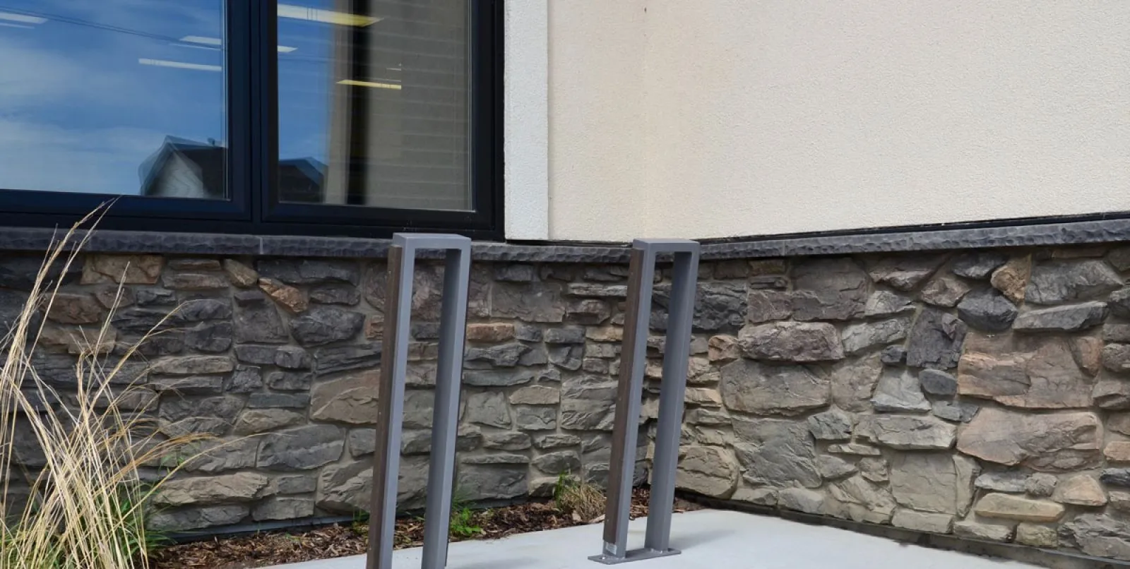 Urban Form bike racks provide secure parking at Sherwood Municipality in Saskatchewan. These durable racks complement the stone facade of the building.