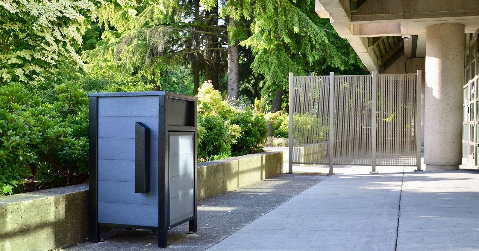Urban Form waste receptacle with ashtray, featuring recycled plastic lumber and powder-coated metal construction. Ideal for commercial or municipal settings.