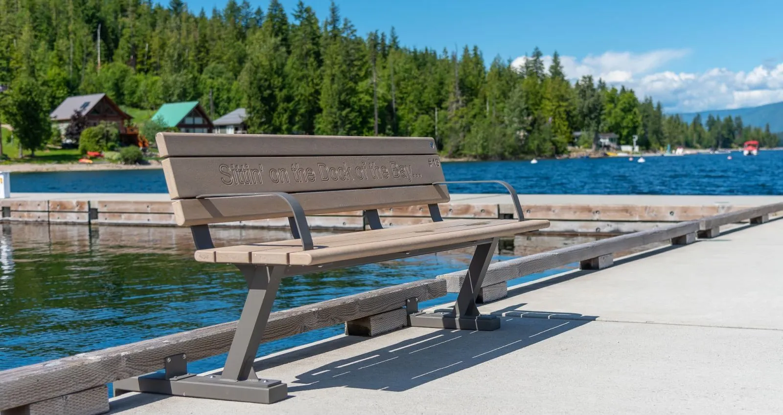 Bayview bench with custom routering, installed on a dock overlooking the lake. This bench provides a comfortable place to sit and enjoy the beautiful view.