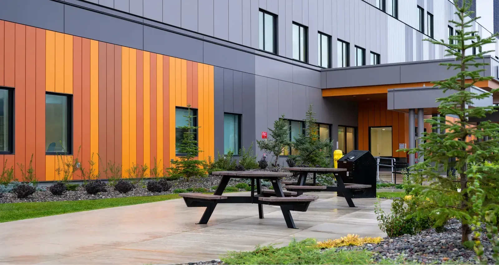 Bayview Hexagonal Picnic Tables provide a gathering space outside the Ksyen Regional Hospital in Terrace, British Columbia. The tables offer a place for visitors and staff to relax and enjoy the outdoor environment.