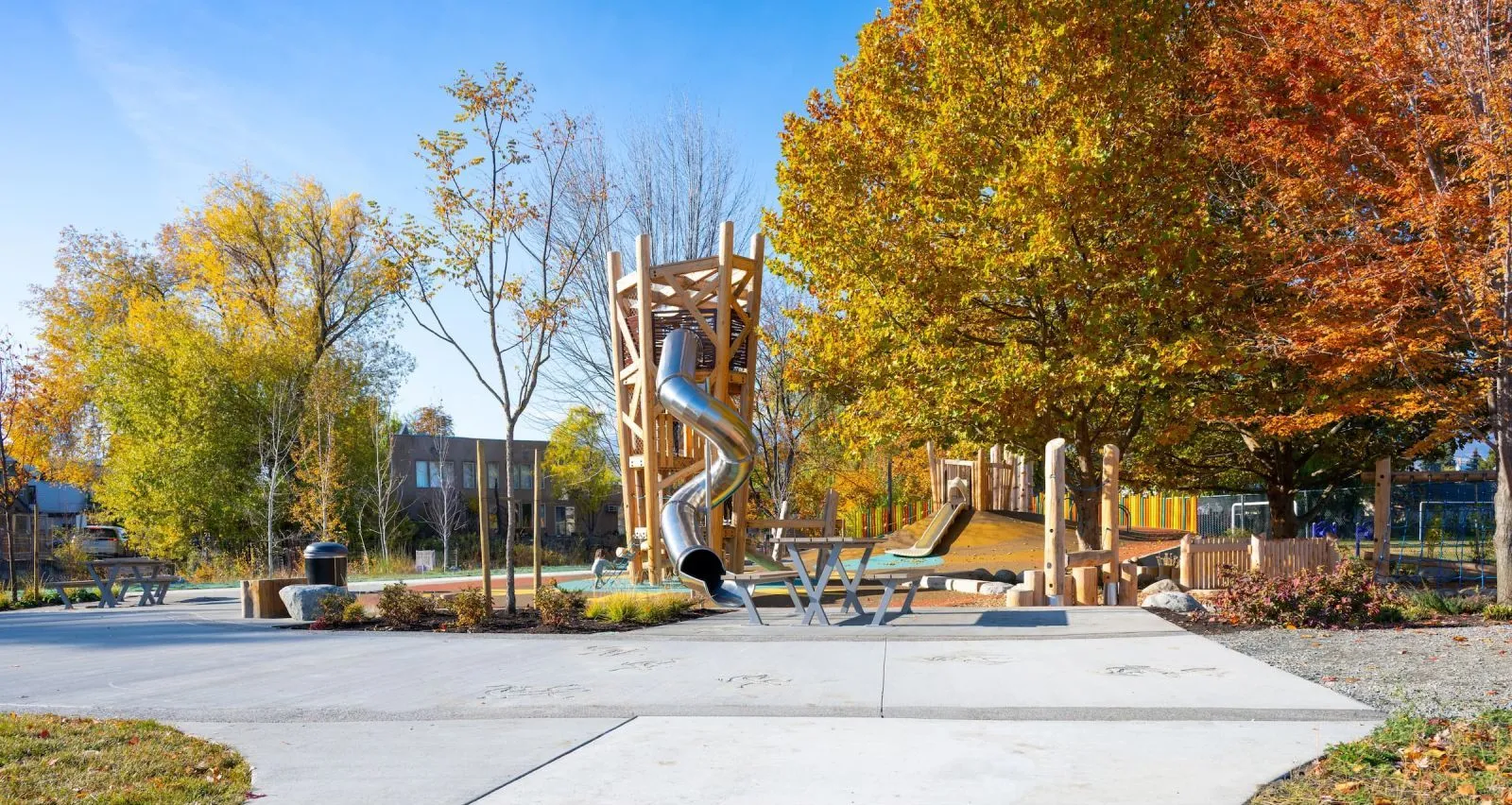 Bayview picnic tables are installed at Burne Avenue Playground in Kelowna, British Columbia. The tables provide a place for park visitors to sit and enjoy the playground.