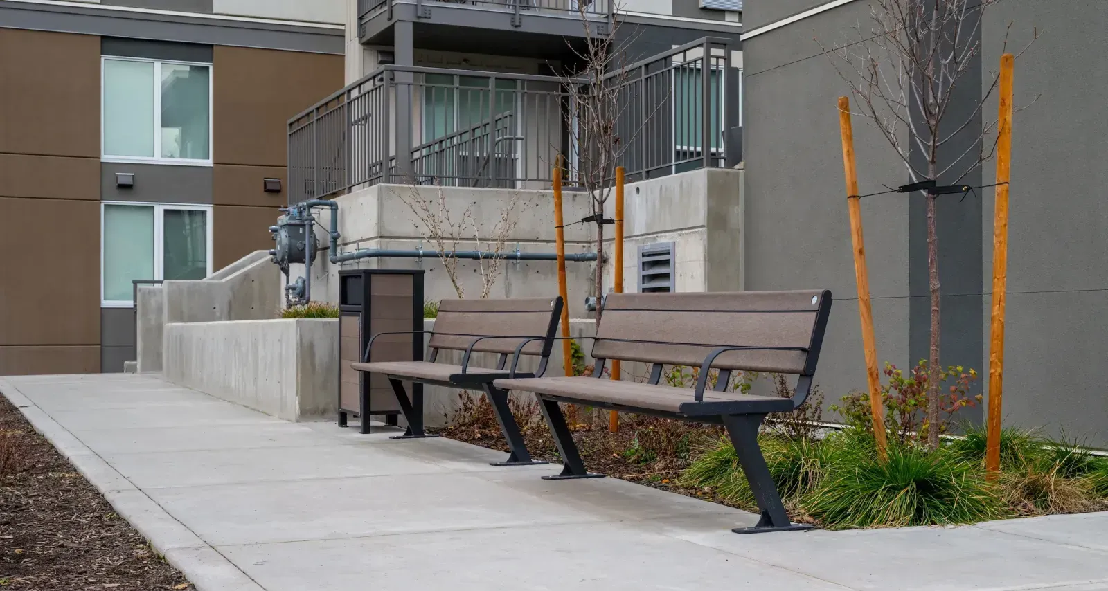 Bayview Plus benches provide comfortable seating in an outdoor area. The benches feature recycled plastic lumber and a durable metal frame.