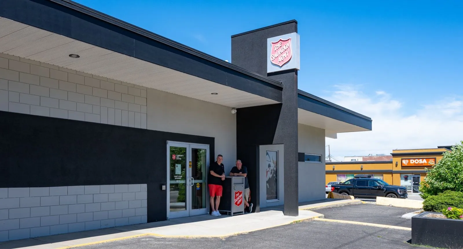 Custom large capacity waste receptacles are installed outside The Salvation Army thrift store in Kelowna, British Columbia. These urban form waste bins provide a convenient and durable solution for managing waste in a commercial setting.