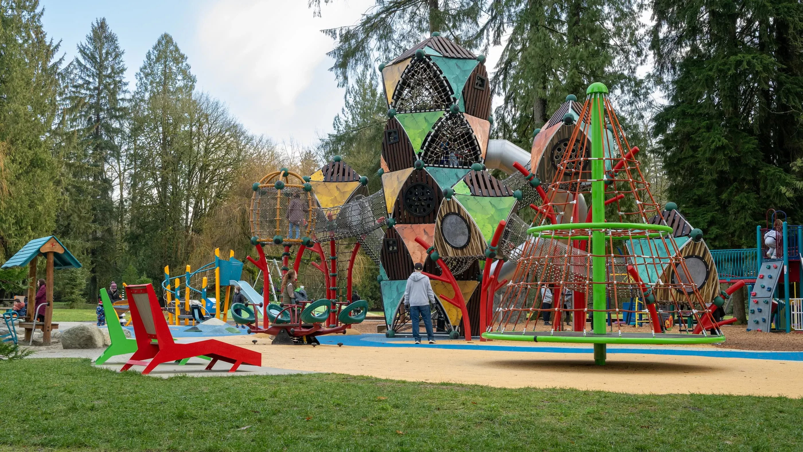 Colorful chaise loungers add a playful touch to the playground at Maple Ridge Park. These outdoor loungers provide a comfortable and stylish seating option for park visitors.
