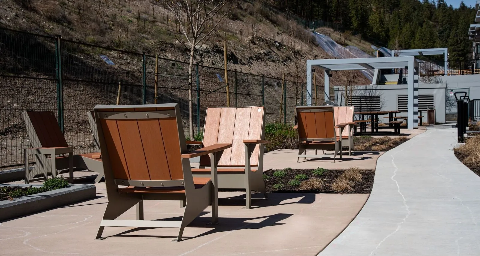 JEM Lounge Chairs provide comfortable outdoor seating at Knox Village in Kelowna, British Columbia. These chairs feature recycled plastic lumber and powder-coated metal frames.