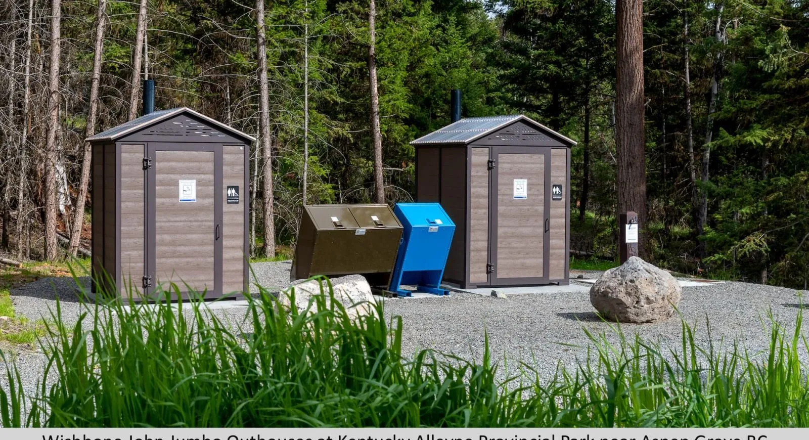 These John Jumbo Outhouses are located at Kentucky-Alleyne Provincial Park near Aspen Grove, BC. The durable structures provide essential facilities in a natural park setting.