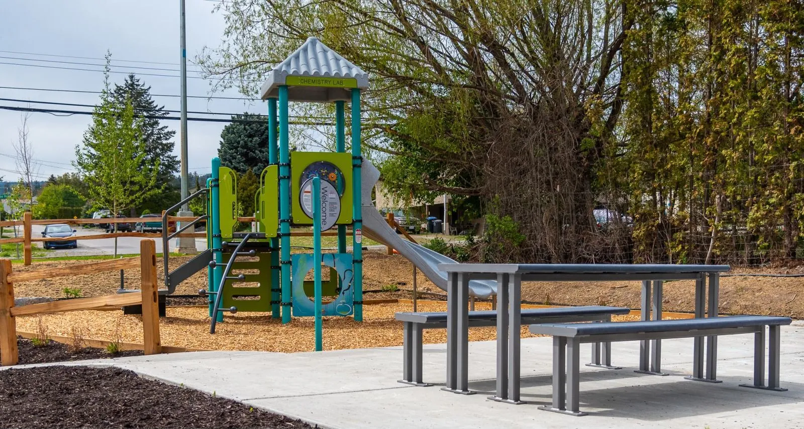 Larson picnic table with powder-coated metal frame at Skygreen Apartments in West Kelowna, British Columbia. The table provides an outdoor seating solution for residents.