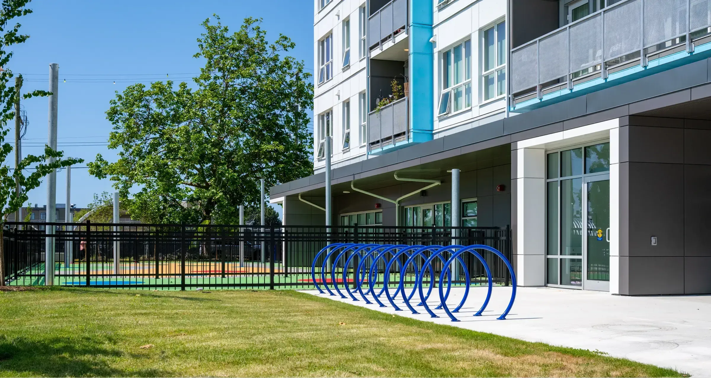 LOOP bike racks provide convenient and secure bicycle parking at The Ferns Affordable Housing Complex. The racks are powder-coated in a vibrant blue.